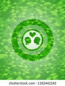 couple in love icon inside green emblem with triangle mosaic background