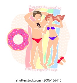 couple in love makes a selfie while lying on the beach. seaside vacations and online communication. relaxing on sea in summer. sunbathe on the sand.