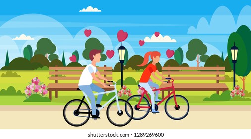 couple in love riding bicycles happy valentines day holiday concept city urban park landscape young man woman lovers cycling bike horizontal flat