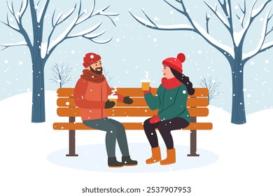 Couple in love sits on a bench in a winter park, holding hot coffee in their hands and having a nice conversation. A man and a woman meet in a park in winter. Romantic Christmas holidays.
