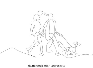 couple in love taking a walk with their dog
