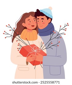 A couple in love in winter clothes give gifts. New Year's decor. Winter branch.Family winter holiday celebration together, girl receive xmas present