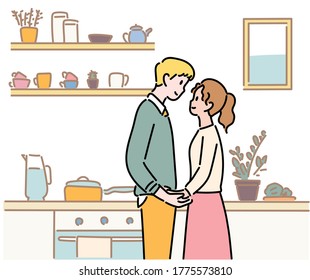 A couple of man and woman stand affectionately looking at each other. Kitchen background. hand drawn style vector design illustrations. 