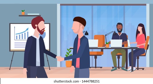 couple men handshaking business partners hand shake during meeting agreement partnership concept co-working center modern office interior flat portrait horizontal