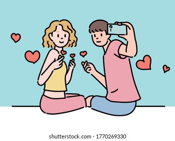 A couple men   women are holding selfies   taking selfies  They are looking back  hand drawn style vector design illustrations 