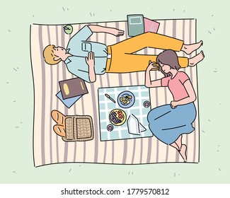 A couple men   women are taking picnic   relaxing in the park  hand drawn style vector design illustrations  
