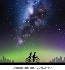 Couple On Bike Tandem In Park. Cyclist On Bicycle. Milky Way At Night