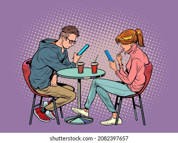 a couple on a date in a restaurant are looking at smartphones and not talking, loneliness and new technologies