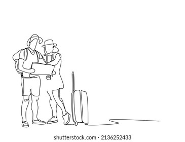 couple on vacation look at map
