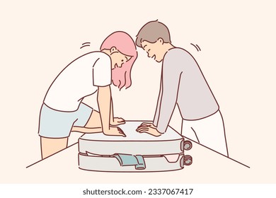 Couple is packing up luggage for travel and trying to close overstuffed suitcase full of clothes. Happy man and woman packing travel bag for vacation trip feeling joyful anticipation of voyage