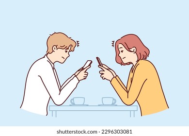 Couple with phones sits in cafe, addiction to social networks and internet chatting, not paying attention to interlocutor. Concept of social problems associated with digital addiction to gadgets