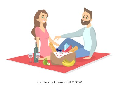 Couple at picnic. Couple sitting in park on blanket with food.