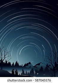 couple in pine forest watching star trail