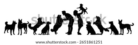 Couple playing with group of dogs side view isolated black silhouettes. Young couple takes care of stray dogs on the street vector silhouette. Man and woman volunteer at a dog shelter graphic.
