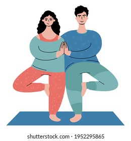 couple practicing yoga together. A man and a woman standing in a tree pose.