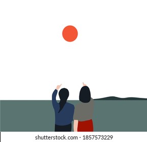 A couple of pretty girl has a fun with her girlfriend enjoying pointing at sun at sunset outside on the beach. LGBT and lesbian consept.