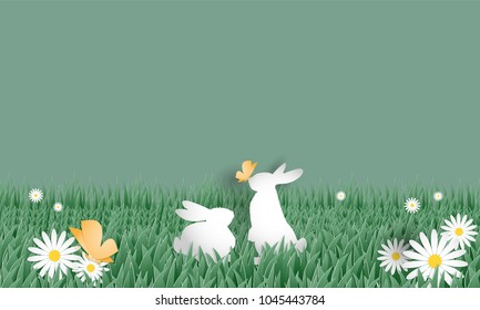 A couple of rabbits in grass field with white flowers and butterfly on light green sky background. Digital craft design in paper art style. Vector illustration.