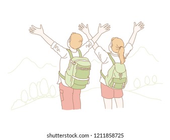Couple raise their hands up and facing the mountain in line style