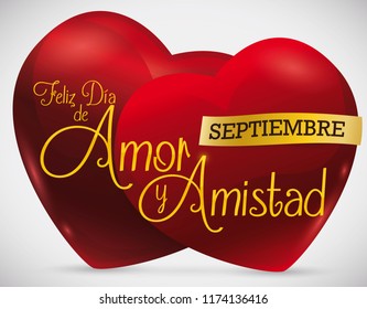 Couple of red hearts with ribbon to celebrate the Colombian tradition of Love and Friendship or "Dia de Amor y Amistad" (written in Spanish) in September.