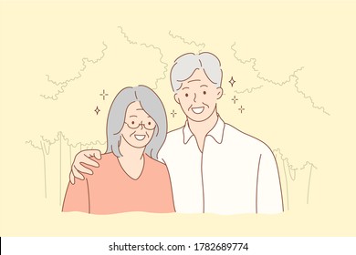 Couple, relationship, embrace, love concept. Old man grandfather and woman grandmother granny senior citizens cartoon characters hugging together and looking at camera. Portrait of elderly pensioners.