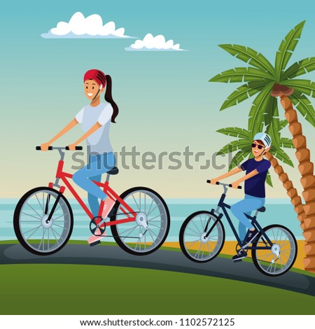 Couple riding bikes at beach