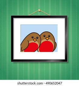 Couple of Robin Red Breasts in Picture Frame Hanging on Green Wallpaper Background