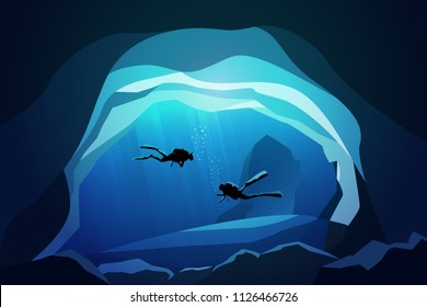 couple of scuba divers underwater in the caves