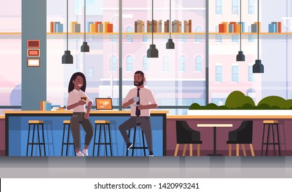 couple sitting on chair at bar counter with laptop coffee break concept african american man woman drinking cappuccino during meeting modern cafe interior flat full length horizontal