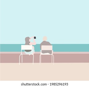 Couple sitting on chair using cellphone camera app taking selfie picture outdoors for social media while travel relax seeing ocean.