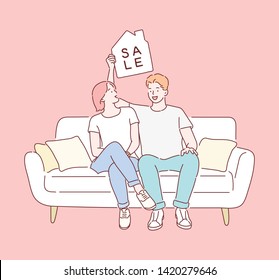 A couple is sitting on the couch with a sale sign. Hand drawn style vector design illustrations.