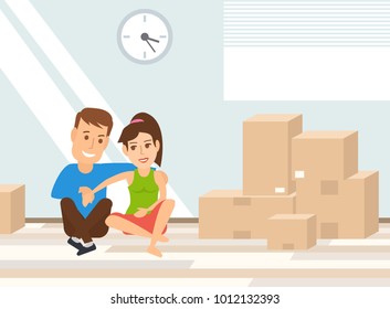 couple sitting on the floor near the cardboard boxes.moving day concept