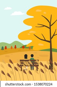 Couple sitting on a hill in autumn.