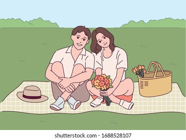 A couple is sitting on a mat in the park. hand drawn style vector design illustrations. 