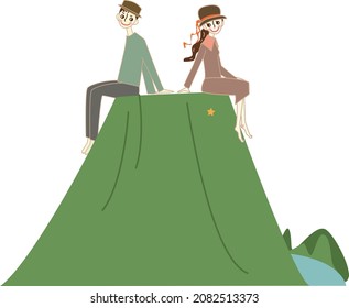 Pareja sentada en la montaña.