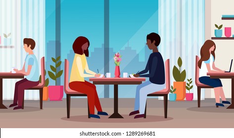 couple sitting at table enjoying food happy valentines day concept holiday dinner african american man woman eating and talking modern restaurant interior horizontal flat