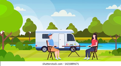 couple sitting at table near camping family trailer truck caravan car man woman spending time together summer vacation concept beautful nature landscape background flat full length horizontal