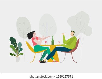 Couple talking in the park cafe with the bottle of wine. Leisure, free time and relationship concept