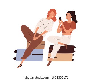 Couple of tourists with luggage waiting for flight. Passengers sitting on suitcases and looking photos in mobile phone. Colored flat cartoon vector illustration of women isolated on white background