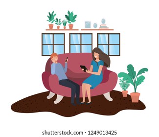 couple using technology devices in livingroom