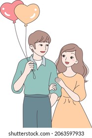 A Couple Is Very Close, The Girl Holds His Arm, The Boy Holds Balloons In His Hand.