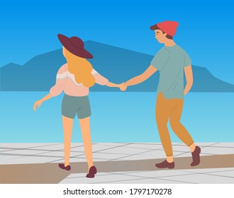 Couple walking in a city park. Young guy and girl holding hands walking in evening alley, romantic walk. Lovers man and woman met on a date outdoor. Romantic promenade in the open air active lifestyle