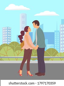 Couple walking in a city park. Young guy and girl holding hands, looking into each other's eyes, romantic walk. Lovers man and woman met on a date outdoor. Romantic promenade in the open air