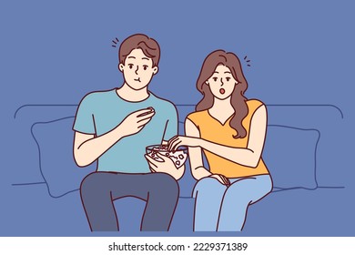 Couple watching movie eating