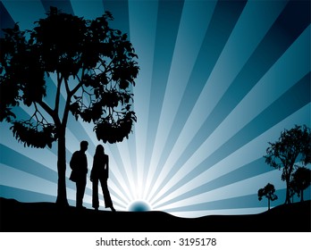 A couple watching the sun rise surrounded by tree