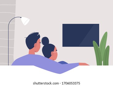 A couple watching TV at home, weekend relaxation, modern lifestyle