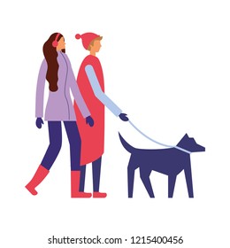 couple with winter clothes walking her dog