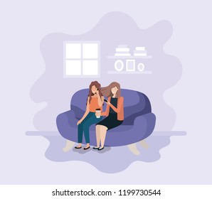 couple of women in living room using technology