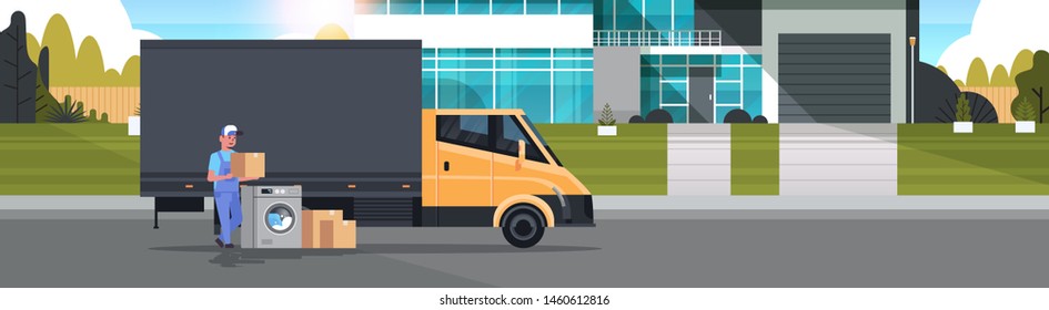 courier man near delivery truck with cardboard boxes washing machine domestic appliances store goods purchase distribution concept cottage house exterior full length horizontal