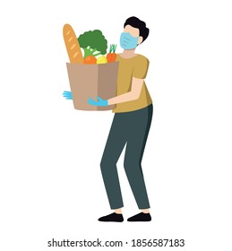 Courier in mask and gloves delivers grocery products. Contactless delivery during coronavirus.