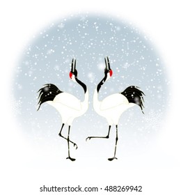 courtship dancing brace of red-crested white cranes in snow